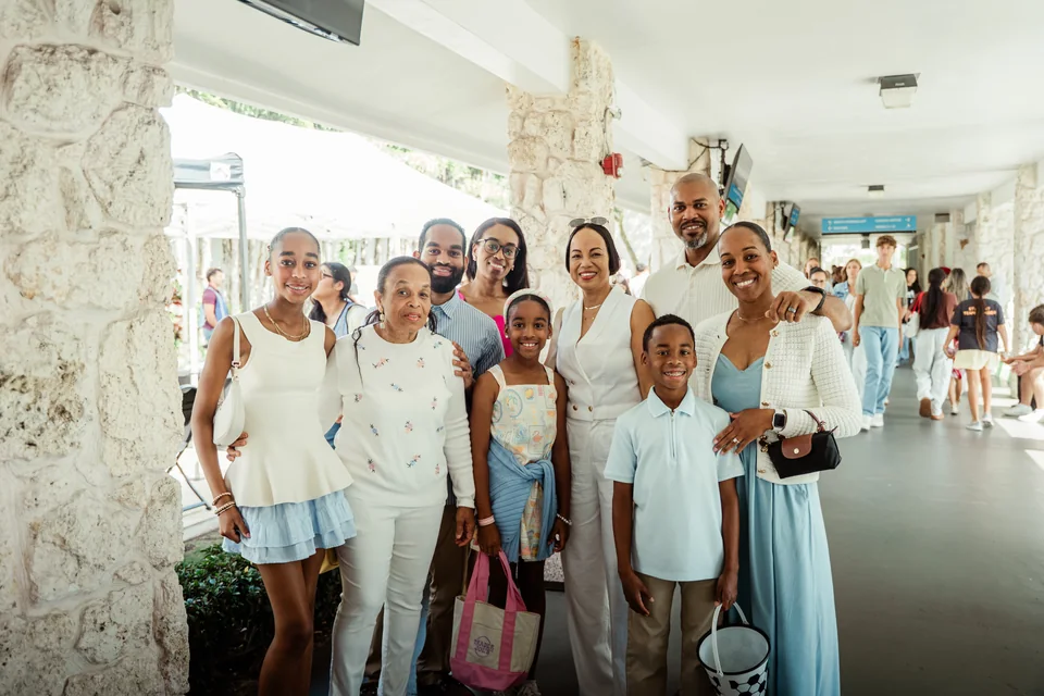 Adults and children smiling together at church.
