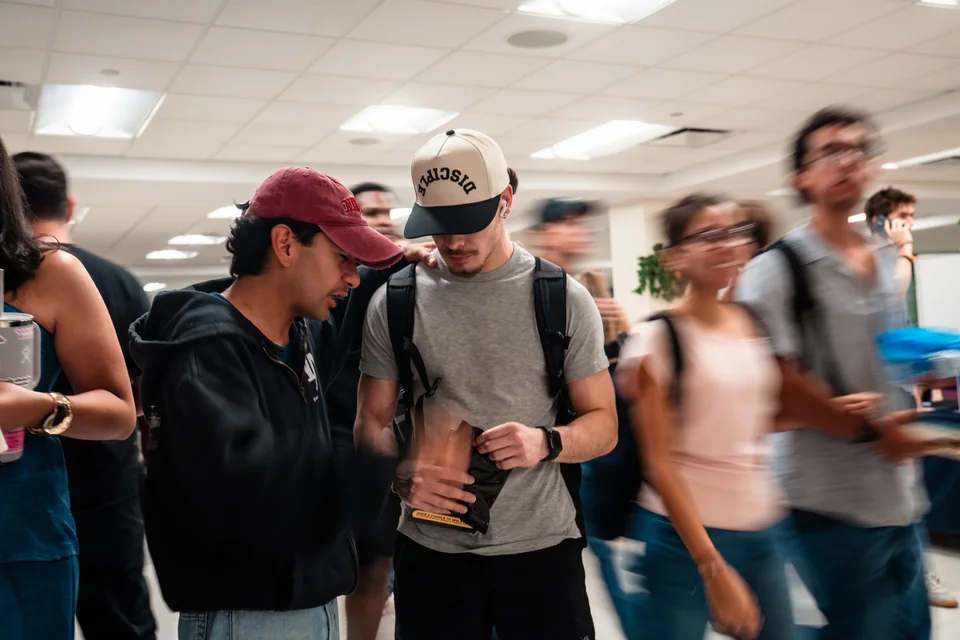 Young adults praying together in community.